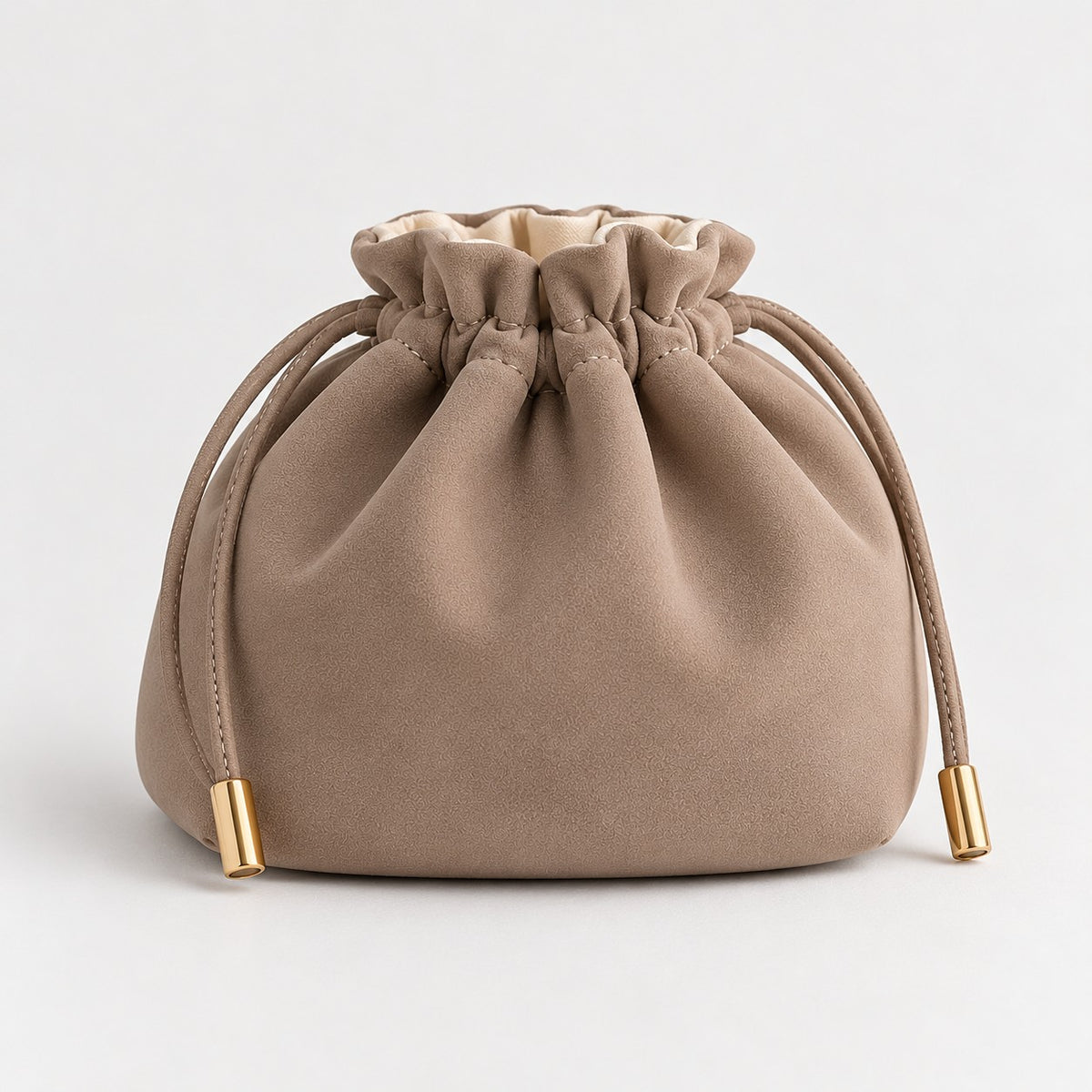 Taupe drawstring makeup bag with gold-tone cord ends