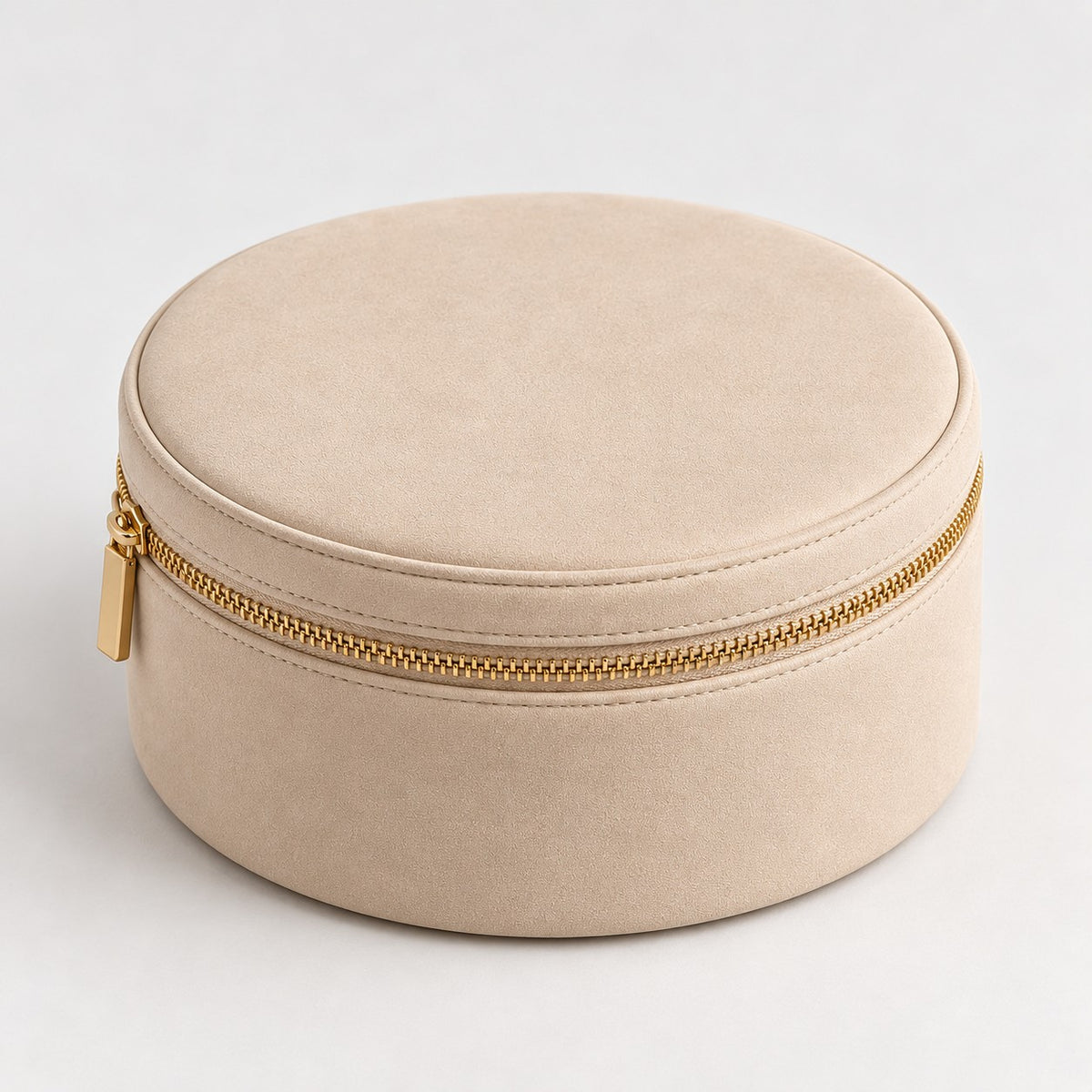 Champagne round makeup case with gold-tone zipper