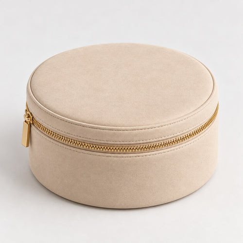 Champagne round makeup case with gold-tone zipper